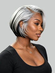 A woman shown in profile wearing a short, layered bob wig with a silver-gray and black ombre effect. The wig is the product being sold, so its colors count.