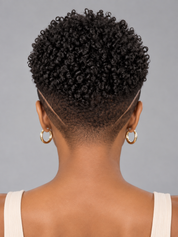 Back view of a person with a short, curly black hairstyle, wearing gold hoop earrings and a white ribbed tank top against a solid gray background.