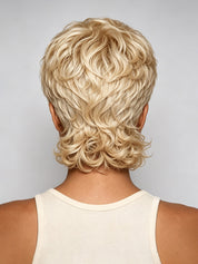 Back view of a person wearing a short, layered blonde wig with textured curls, shown against a light gray studio background.