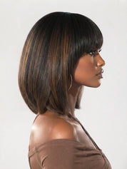 A woman shown in side profile wearing a shoulder-length straight wig with bangs. The wig has a dark brown base with warm caramel and light brown highlights throughout.