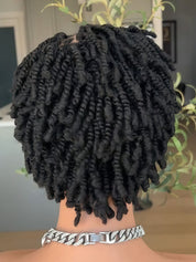 Black twisted locs hair extensions shown from the back on a mannequin head, featuring a chunky silver Cuban link chain necklace.