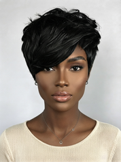 A woman with a short, layered, textured black wig or hairpiece shown from the chest up against a light gray studio background.
