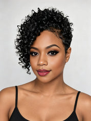 A close-up portrait of a woman with short, curly black hair, wearing a black spaghetti-strap top against a light gray studio background.