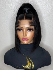 A black straight wig with a high top ponytail and center part, displayed on a mannequin bust wearing a black turtleneck with a gold graphic.