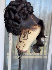 A dark brown to black wavy lace front wig styled in an elegant updo with curls, displayed on a mannequin head stand in front of a window.