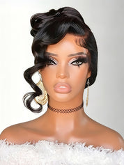 A mannequin bust wearing a glossy black wavy wig with a twisted top knot and side-swept bangs, styled with dramatic eye makeup, gold earrings, and a black choker against a light gray background.
