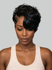 A woman with a short, curly black wig wearing a light beige ribbed tank top, shown against a solid light gray background.