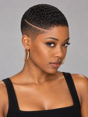 A woman with a short, textured black hairstyle and a clean side part, wearing large gold hoop earrings and a black ribbed tank top against a solid gray background.