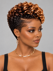 A woman with a short, voluminous curly wig in dark brown and copper-blonde tones, styled with a side part, against a solid gray background.