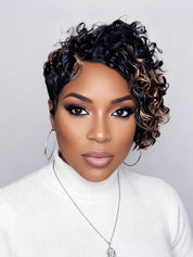A close-up portrait of a woman with a short, curly wig. The wig features a dark black base with warm caramel and light brown highlights, styled in tight, defined curls.