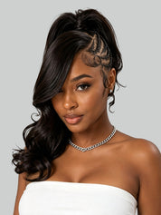 A woman modeling a dark brown to black wavy half-up wig with a side part, braided detail along the hairline, and curled side sections, paired with a white strapless top against a light gray background.