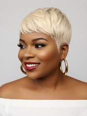 A woman with a short, layered platinum blonde wig, styled with gold hoop earrings and red lipstick, shown against a plain light gray background.