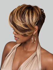 A woman shown in profile wearing a short, layered wig with dark brown and warm blonde highlights, styled with a side-swept bang and a short back. She is wearing a beige halter top and large gold hoop earrings against a plain light gray background.