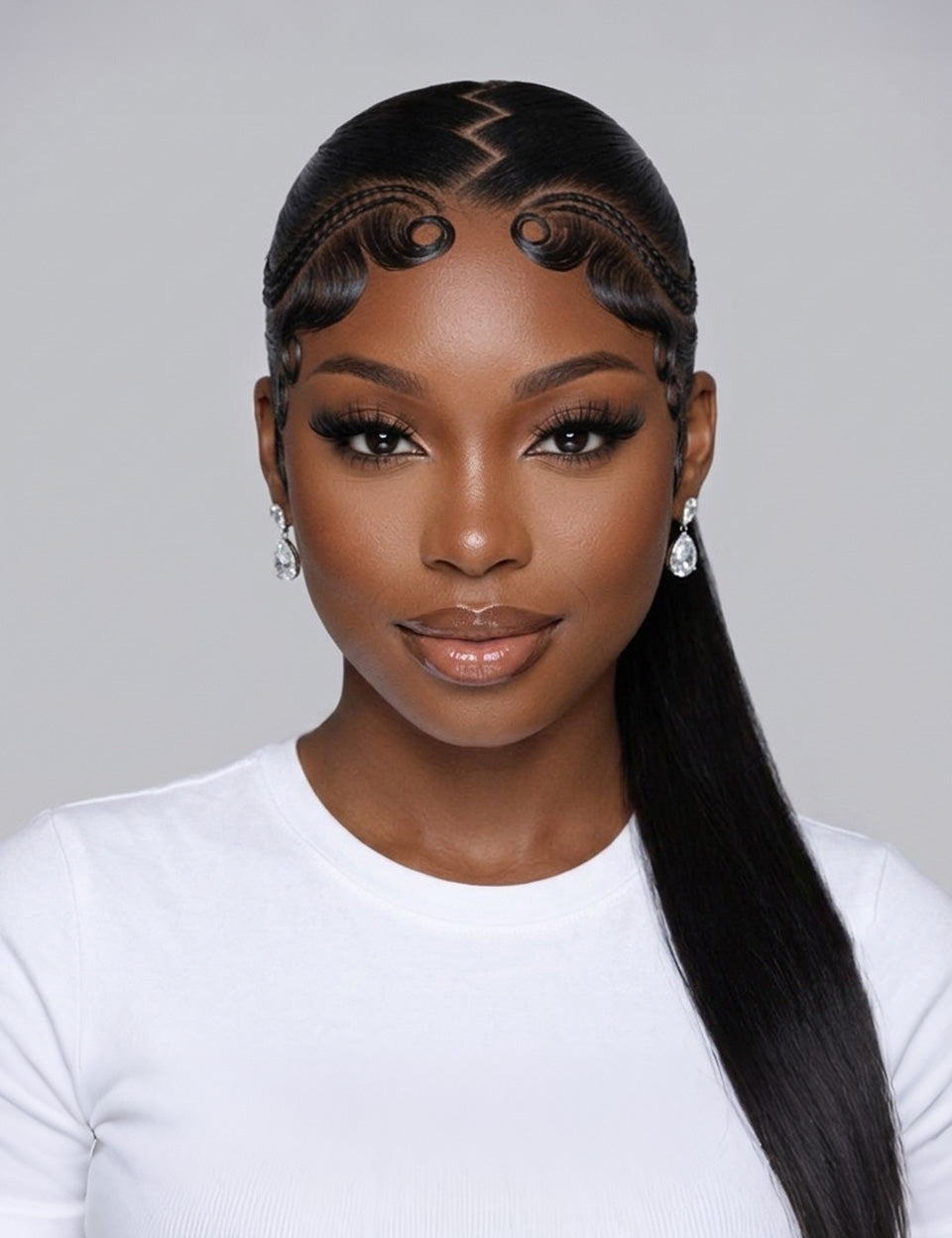 A woman with a long, straight black wig styled with a zigzag part, curled side sections, and a low ponytail, wearing a white top against a light gray background.