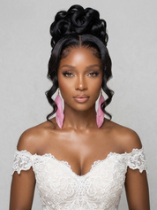 A woman modeling a black lace front wig with a high, voluminous rolled updo and side-swept curls, wearing a white lace off-the-shoulder dress and pink feather earrings against a light gray background.