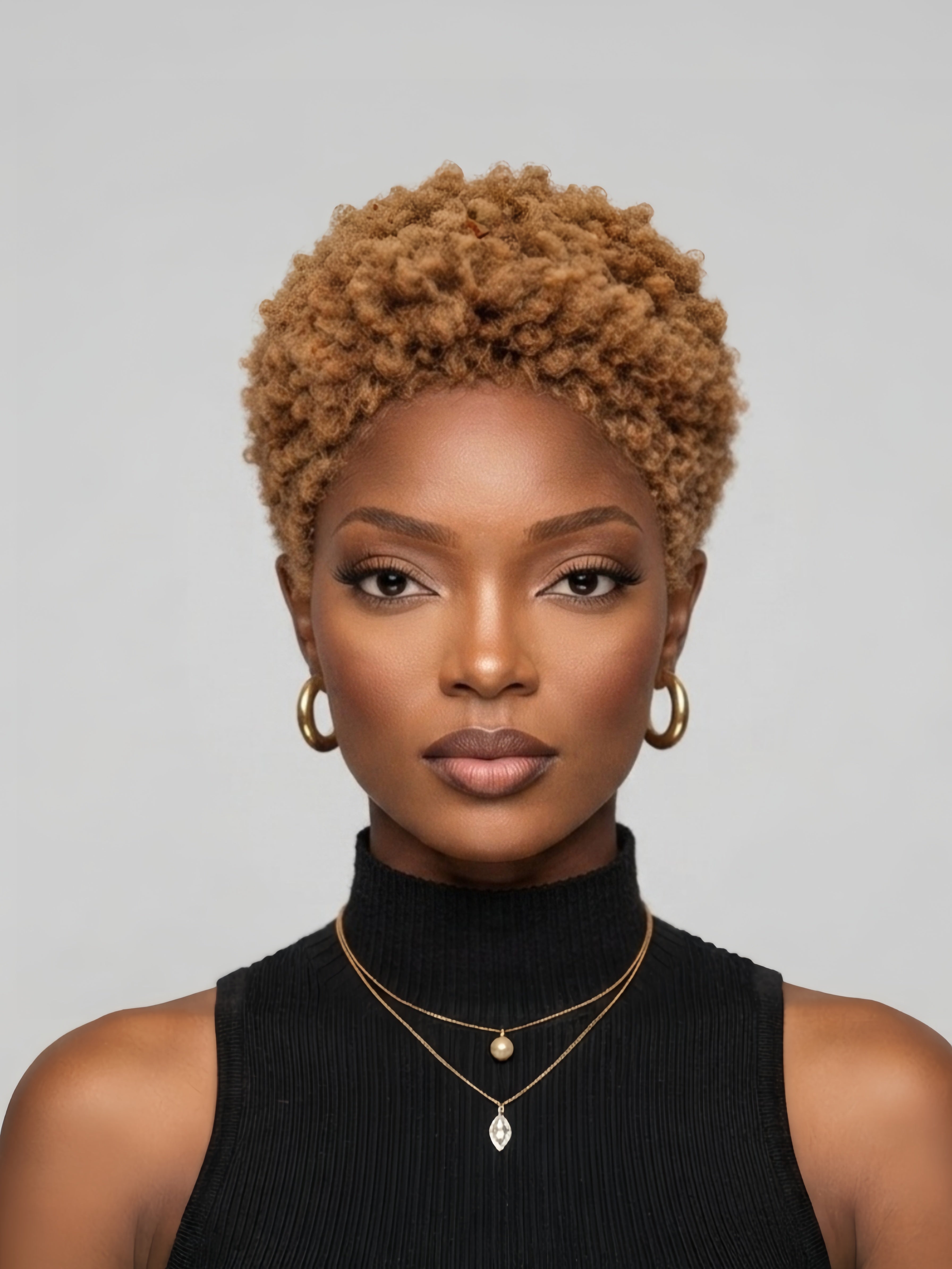 Front view of a woman wearing a honey blonde lowcut afro wig. This 6-inch glueless human hair pixie cut features tight kinky curls and a natural hairline, styled for a bold and trendy look.