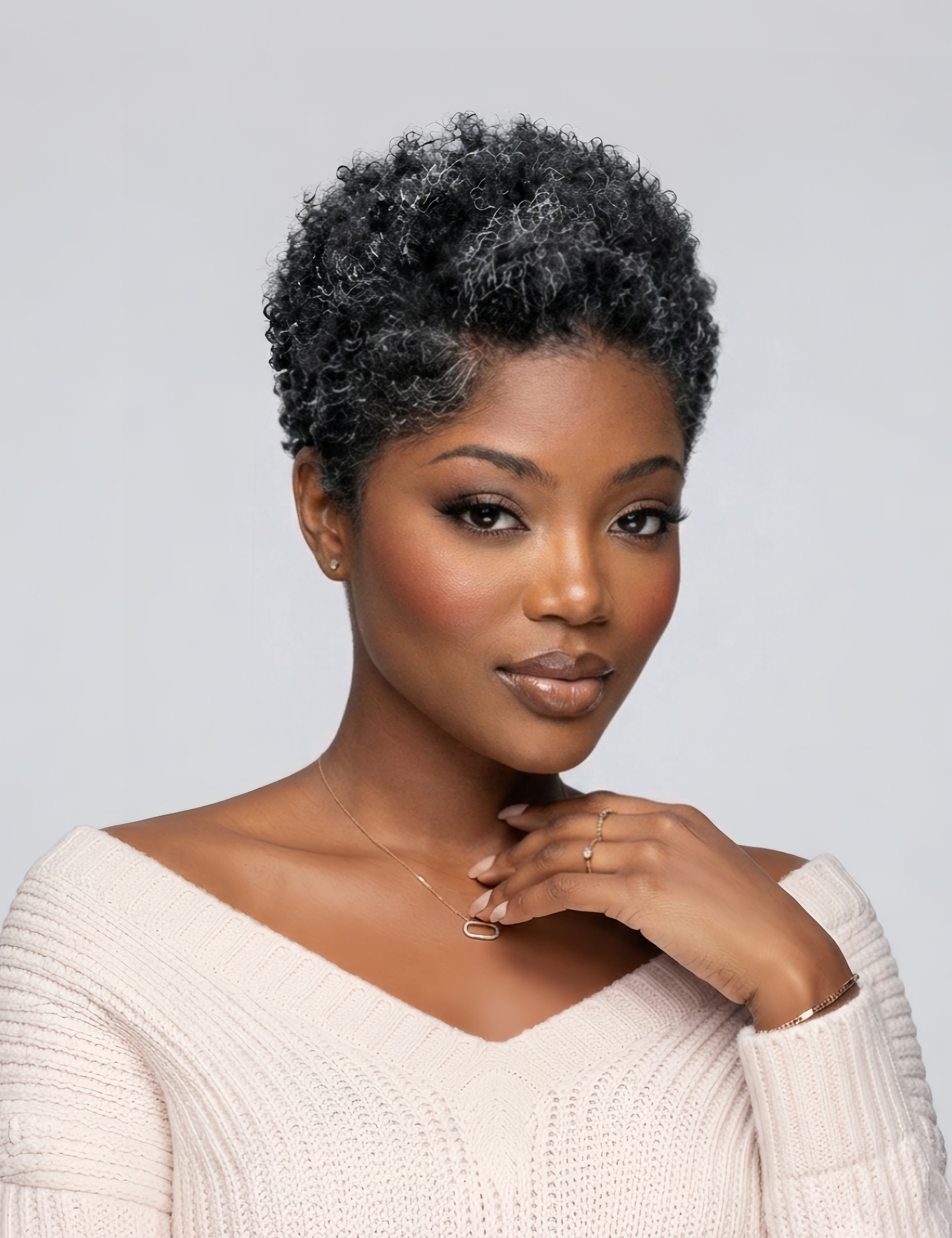 Side angle of a stylish salt and pepper grey afro wig. This 6-inch short curly wig blends black and grey strands for a mature, sophisticated look, featuring a breathable lace front and soft texture