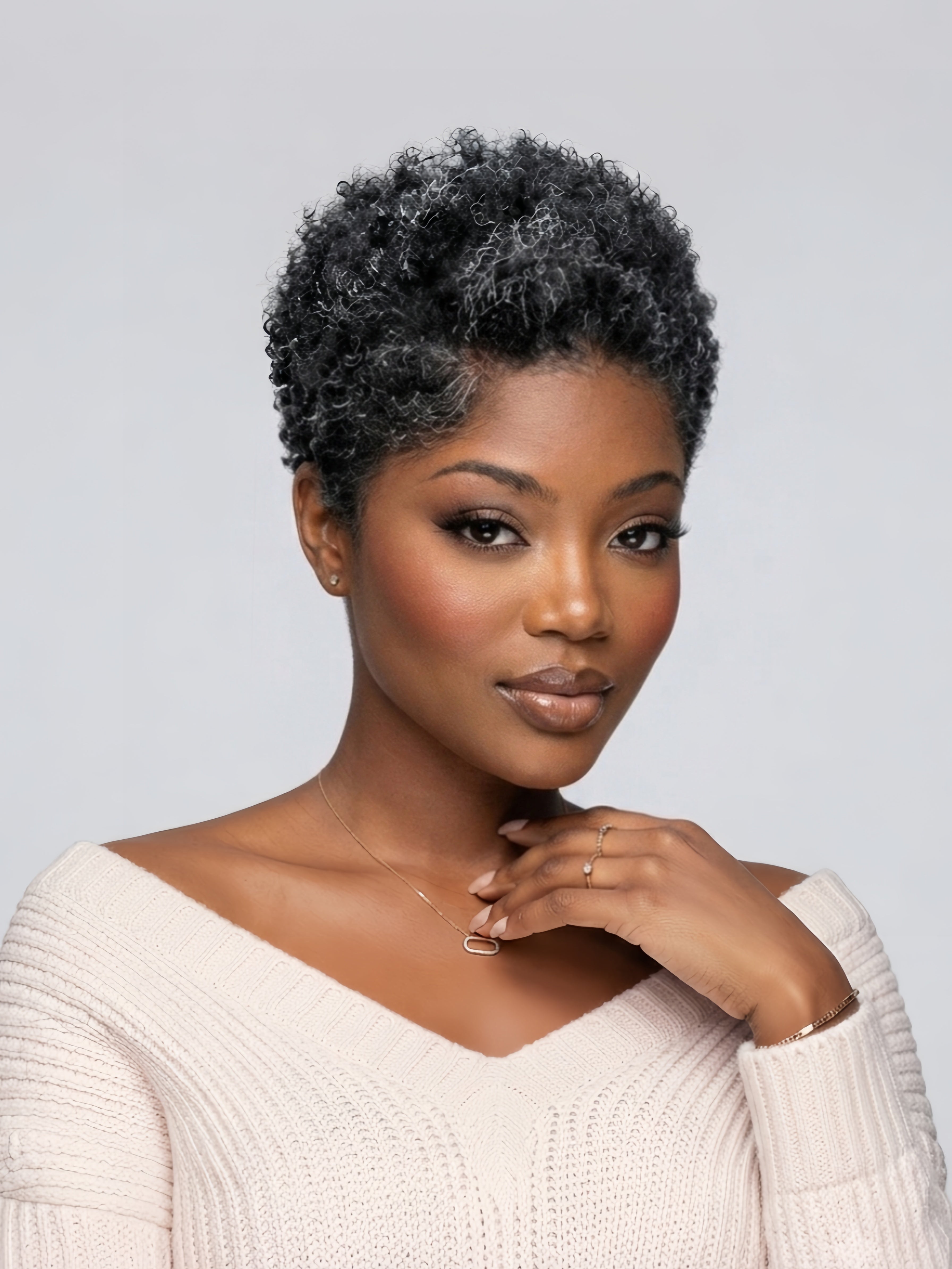 Side angle of a stylish salt and pepper grey afro wig. This 6-inch short curly wig blends black and grey strands for a mature, sophisticated look, featuring a breathable lace front and soft texture