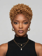 Front view of a woman wearing a honey blonde lowcut afro wig. This 6-inch glueless human hair pixie cut features tight kinky curls and a natural hairline, styled for a bold and trendy look.