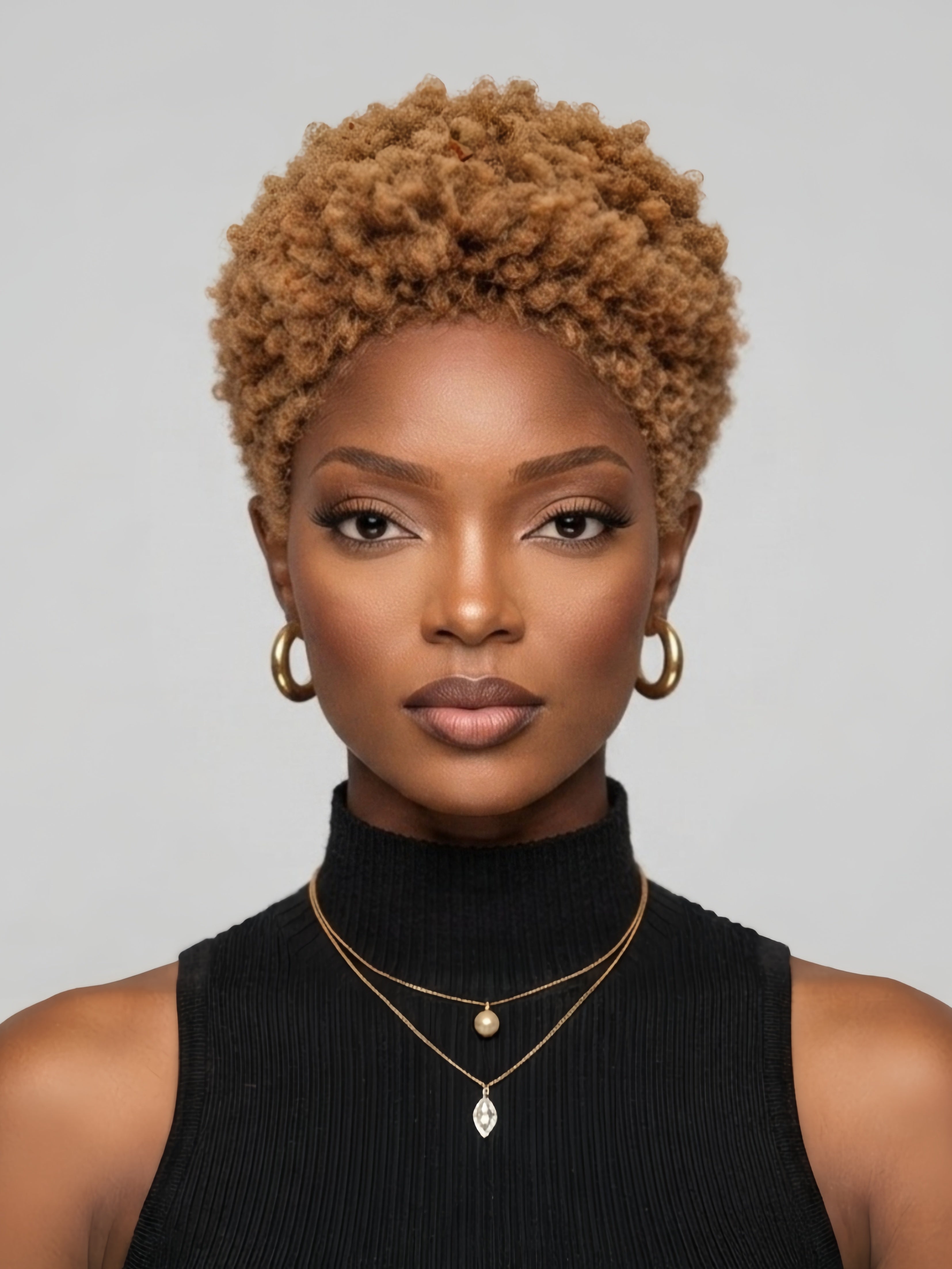 Front view of a woman wearing a honey blonde lowcut afro wig. This 6-inch glueless human hair pixie cut features tight kinky curls and a natural hairline, styled for a bold and trendy look.