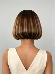 Back view revealing the tapered nape cut and smooth layering of the short wig topper. The clean finish at the neckline demonstrates the precise craftsmanship and natural fall of the human hair.