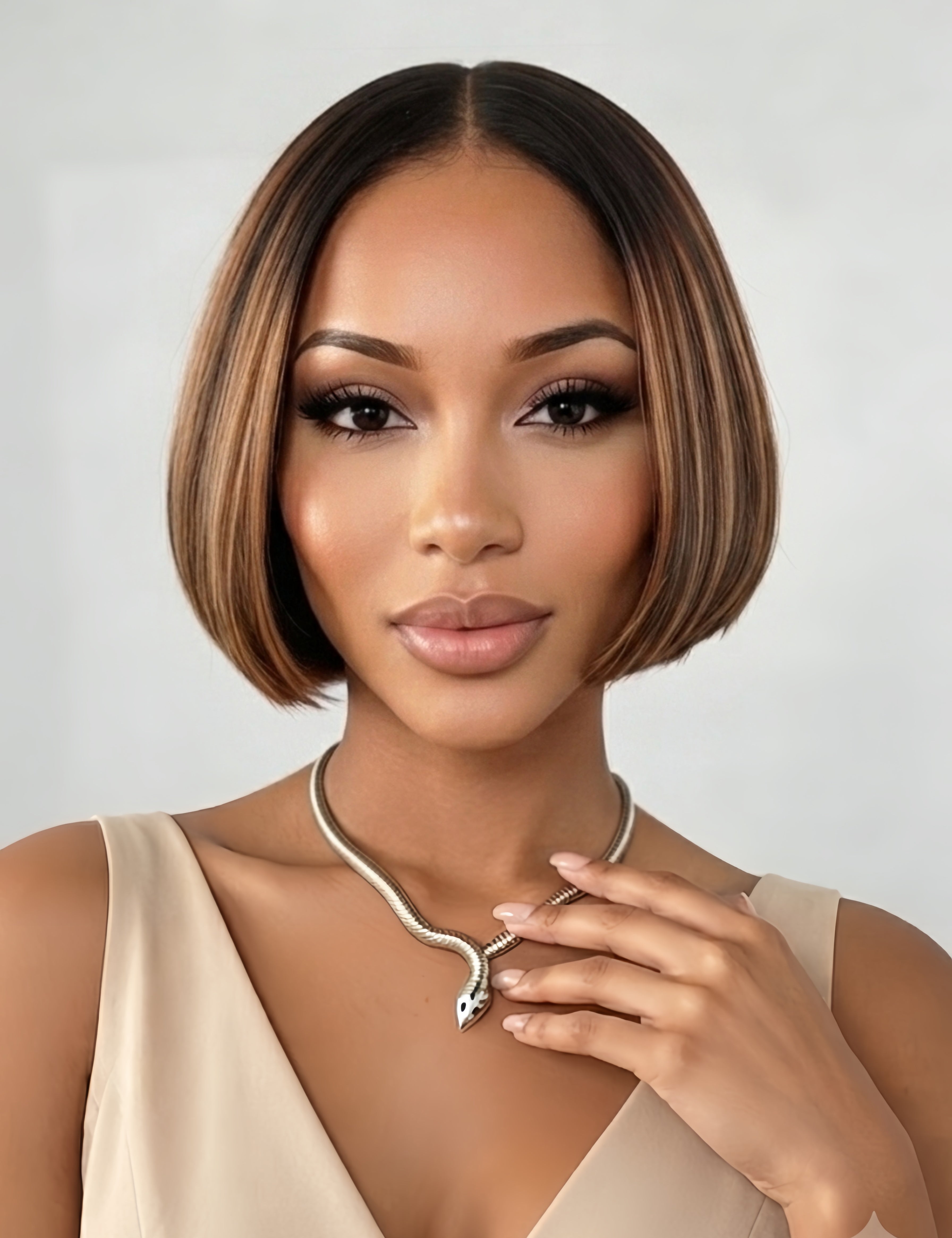 Front view of a woman wearing a sleek brown bob topper with beige blonde highlights. The natural middle parting and smooth texture blend seamlessly with her bio hair, offering a realistic solution for thinning crowns.