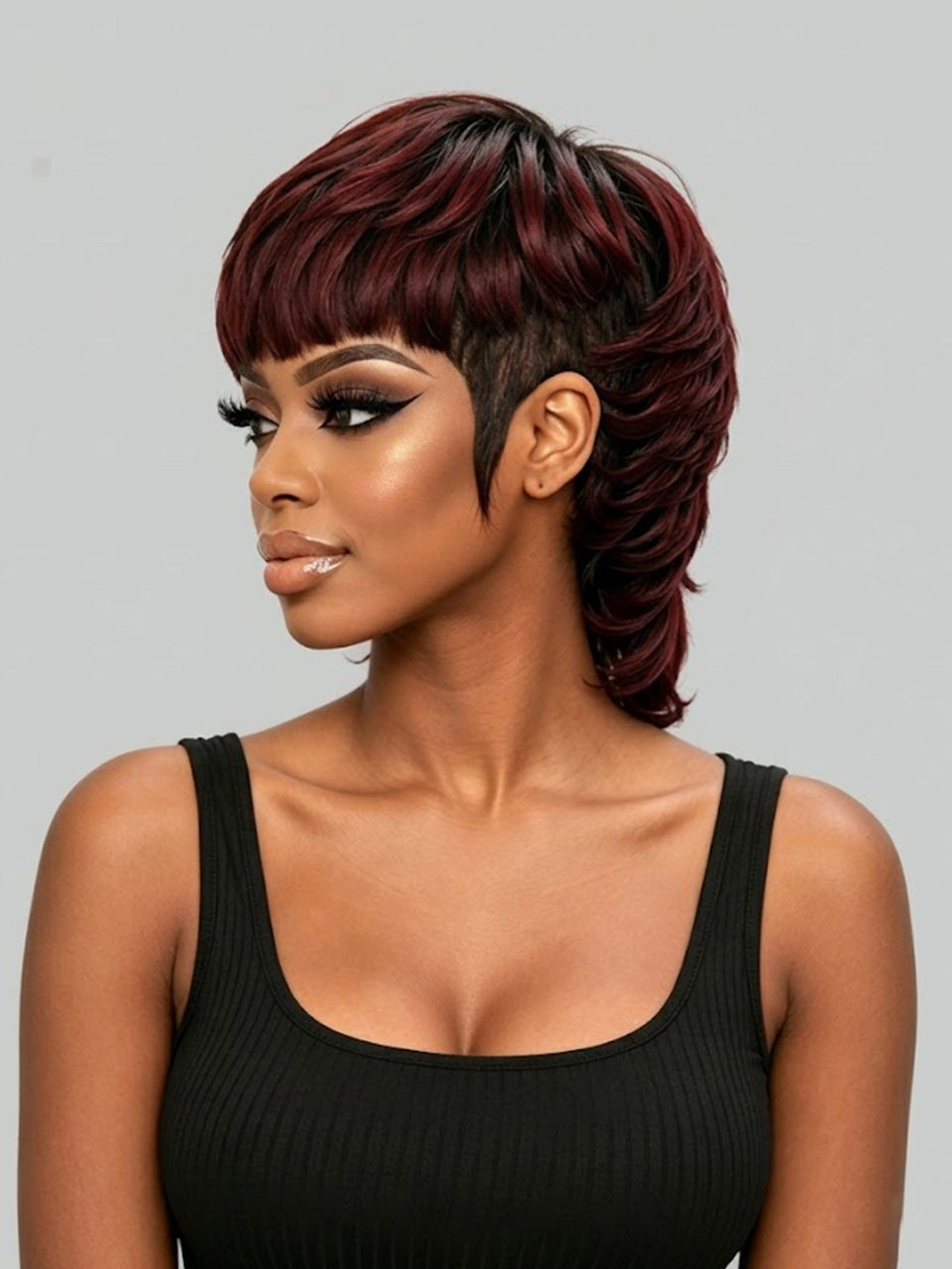 A woman modeling a short, layered wig with deep burgundy and dark brown tones, styled with a side-swept bang and undercut, against a solid gray background.