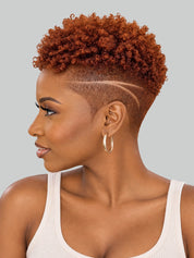 A woman in profile wearing a short, curly auburn wig with a high undercut and geometric line detail on the side, paired with gold hoop earrings and a white ribbed tank top, against a solid gray background.