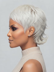 Side profile view of a woman wearing a platinum silver short pixie wig. The hairstyle features a tapered nape with flipped-out ends and textured layers around the ear, showcasing a modern and edgy silhouette.