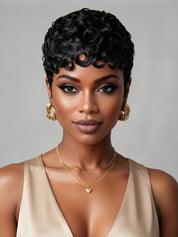 Front view of a woman wearing a short black curly pixie wig with defined finger coils. The tight spiral texture and natural hairline create a bold, retro-inspired look that frames the face perfectly.