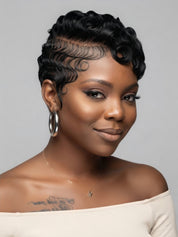 Side profile of a woman wearing a black full lace pixie wig with defined pin curls on top. The short human hair wig features a tapered nape and natural sideburns, showcasing a chic retro look.