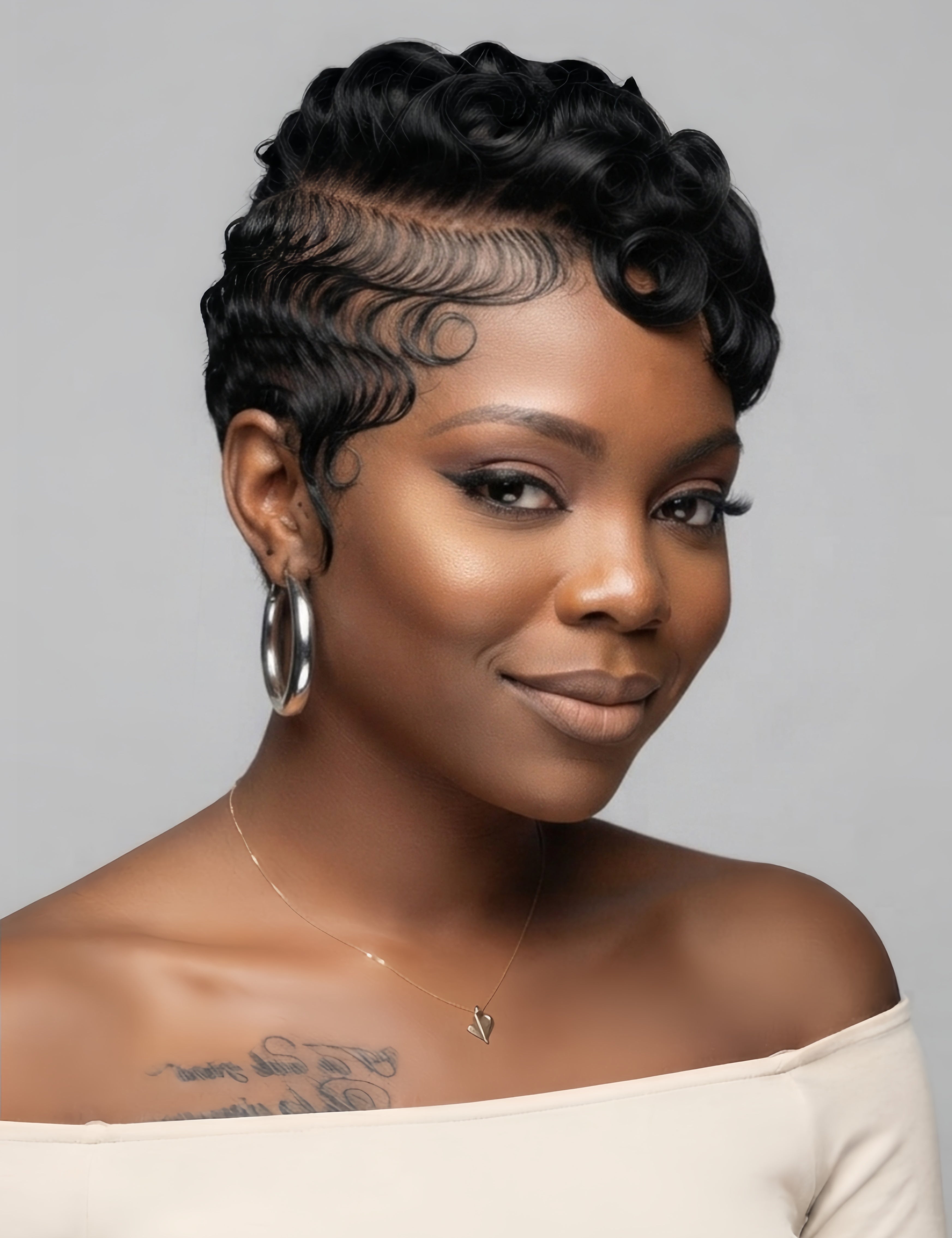 Side profile of a woman wearing a black full lace pixie wig with defined pin curls on top. The short human hair wig features a tapered nape and natural sideburns, showcasing a chic retro look.