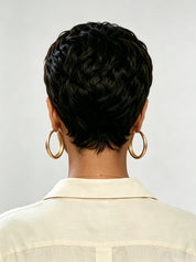 Back view of a woman wearing a short black curly pixie wig with tight wave texture. The tapered nape and layered back create a full, rounded silhouette, showcasing the wig’s natural volume and precision cut.