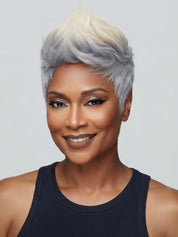Frontal portrait of a woman wearing a stylish gray and white short pixie cut wig. The glueless human hair wig frames the face perfectly with a spiky, voluminous top and realistic hairline.