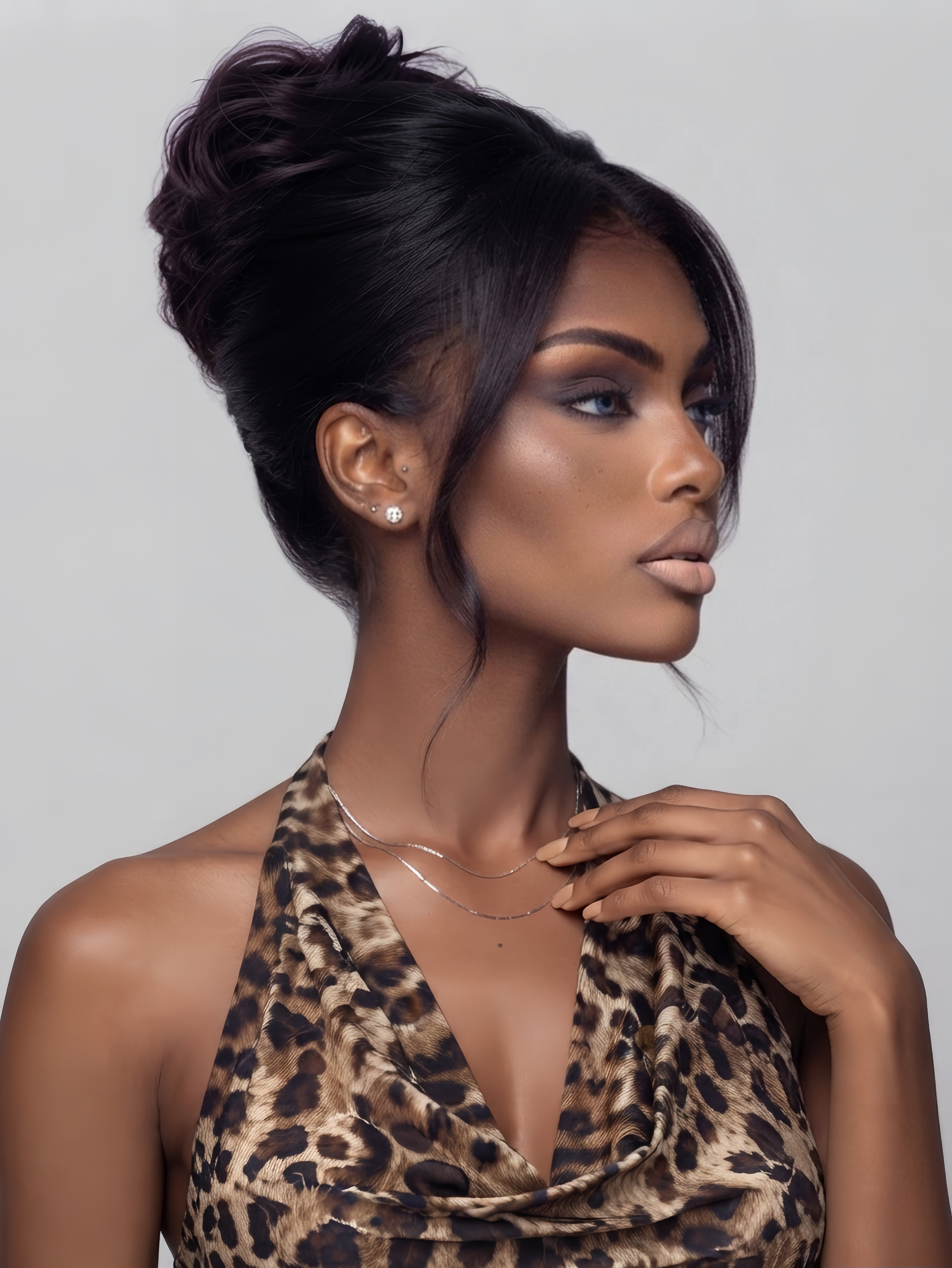 Side profile of a model showing the texture and volume of a messy high bun human hair wig. The sleek black hair is pulled back, highlighting the realistic silhouette and ear tabs.