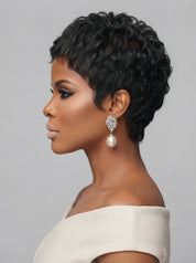 Side profile of a model wearing a short curly wig with salt and pepper tones, emphasizing the sculpted silhouette and the way curls hug the ear. The sleek neckline and textured layers highlight a modern, low-maintenance style, accented by a dangling pearl earring.