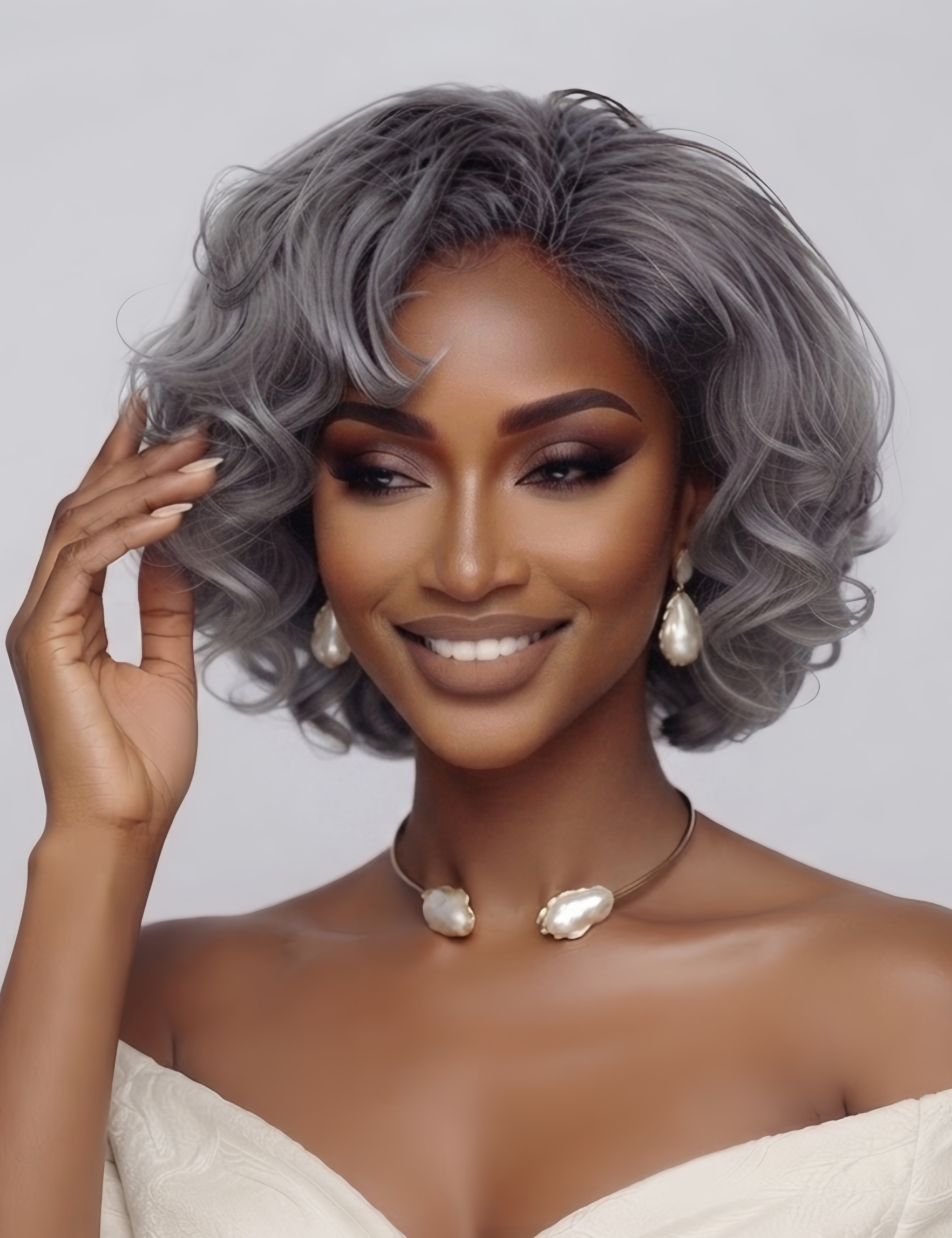 Front angled view of a woman wearing a silver grey short curly bob wig with side-swept bangs. The model gently touches the soft, voluminous waves, highlighting the natural movement and fluffy texture of the grey hair.