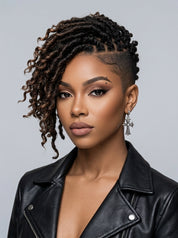 A close-up portrait of a woman with styled dark brown to black micro-dreadlocks or braided twists on the left side of her head, paired with a shaved side and a black leather jacket against a light gray studio background.