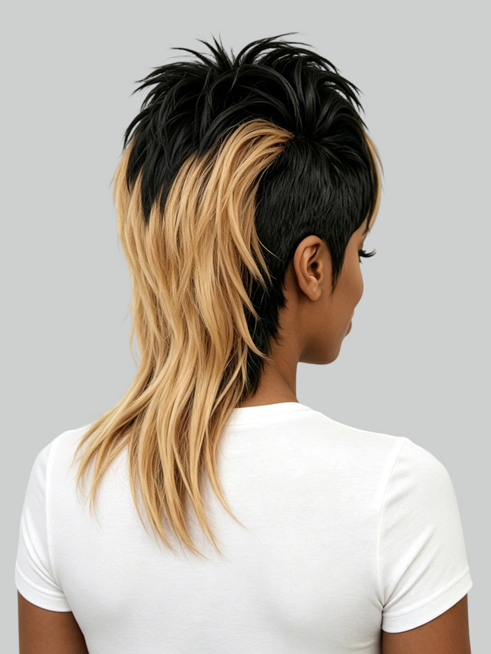 A person shown from the back wearing a short, spiky hairstyle with a black top section and long blonde side layers, paired with a plain white T-shirt against a light gray background.