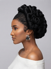A woman shown in profile wearing a black braided hair extension with a large, voluminous twisted updo. She is wearing a white off-the-shoulder knit top and silver geometric earrings, set against a solid light gray studio background.