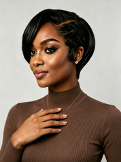A woman shown in side profile wearing a short, layered, textured wig in dark black with subtle brown highlights, paired with a white crew-neck t-shirt and small hoop earrings against a light gray background.