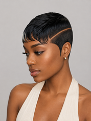 A woman with a short, styled black wig or hairpiece shown in profile against a light gray studio background. The hair has a sharp side undercut and a fine front fringe, with a warm beige highlight line running through the crown.