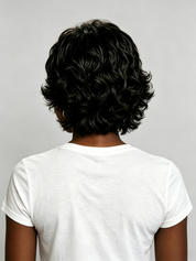 Back view of a person with short, curly black hair wearing a plain white t-shirt against a light gray background.