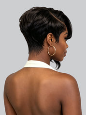 A woman shown from the back and side wearing a short, dark brown wig with a side part and curled bangs, paired with large gold hoop earrings against a light gray background.